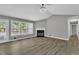 Bright living room featuring wood flooring, large windows, and cozy fireplace at 52 Malcolm Dr, Clayton, NC 27520