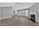 Open-concept living room with wood flooring and fireplace, ideal for entertaining at 52 Malcolm Dr, Clayton, NC 27520