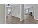 Open-concept interior with hardwood floors, showcasing a view into the kitchen and fireplace at 52 Malcolm Dr, Clayton, NC 27520