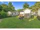 Expansive fenced backyard featuring a fire pit and shed, perfect for outdoor entertaining at 527 N Cypress St, Wendell, NC 27591