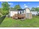 Exterior angle showing a backyard with shed, patio area, fenced-in grass, deck, and garden at 527 N Cypress St, Wendell, NC 27591
