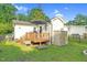 Charming backyard features a wooden deck with an umbrella, storage shed and well-maintained lawn at 527 N Cypress St, Wendell, NC 27591