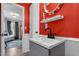 Bathroom featuring a dark faucet on a sink with bright red walls and white trim at 527 N Cypress St, Wendell, NC 27591