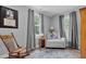 Cozy bedroom featuring neutral walls, natural light and a rocking chair next to a sitting chair at 527 N Cypress St, Wendell, NC 27591
