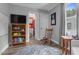 Bedroom view with a TV, bookcase and entry to a brightly colored bathroom at 527 N Cypress St, Wendell, NC 27591