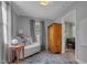 Bright bedroom featuring neutral walls, natural light and a wooden armoire at 527 N Cypress St, Wendell, NC 27591