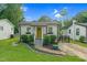 Charming cottage with yellow door, nice landscaping and a Wendell water tower at 527 N Cypress St, Wendell, NC 27591