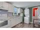 Bright kitchen featuring white cabinetry, modern appliances, and a window for natural light at 527 N Cypress St, Wendell, NC 27591