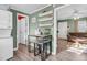 Functional eat-in kitchen featuring a dinette set, open doorway to the living room and decor shelves at 527 N Cypress St, Wendell, NC 27591