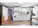 Efficient kitchen featuring white cabinets and modern appliances, connected to living area at 527 N Cypress St, Wendell, NC 27591