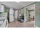 Efficient kitchen space with stacked washer/dryer unit, dinette set and open doorway at 527 N Cypress St, Wendell, NC 27591