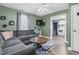 Comfortable living room with gray sofa, flat screen TV, ceiling fan and open view to the kitchen at 527 N Cypress St, Wendell, NC 27591