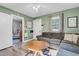 Inviting living room featuring a comfortable sofa, ceiling fan, and natural light from a window at 527 N Cypress St, Wendell, NC 27591
