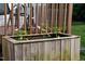 Close up shot of a planter box with young plants growing on a brown deck at 527 N Cypress St, Wendell, NC 27591