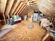 Unfinished attic space with exposed beams, wood floor, and lots of storage possibilities at 55 Ridge Haven Dr, Louisburg, NC 27549