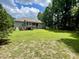 Large backyard with wooden deck, screened in porch, and mature trees at the property's edge at 55 Ridge Haven Dr, Louisburg, NC 27549