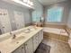Bright bathroom with double sinks, bathtub, and ample natural light at 55 Ridge Haven Dr, Louisburg, NC 27549