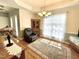 Bright dining room featuring a wood hutch, recliner, elegant chandelier, and hardwood floors with area rug at 55 Ridge Haven Dr, Louisburg, NC 27549