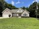 Well-maintained home with an attached garage and lush lawn, complemented by a flagpole at 55 Ridge Haven Dr, Louisburg, NC 27549