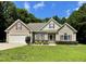 Charming single-Gathering home featuring a well-manicured lawn, attached garage, and inviting front porch at 55 Ridge Haven Dr, Louisburg, NC 27549