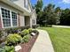 Landscaped pathway leading to a charming home, accentuated with a flagpole at 55 Ridge Haven Dr, Louisburg, NC 27549