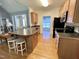 Modern kitchen featuring an island with stool seating, stainless appliances, and an open transition to other living spaces at 55 Ridge Haven Dr, Louisburg, NC 27549