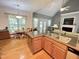 Bright kitchen featuring hardwood floors, an eat-in area with lovely window, and seamless flow into the living room at 55 Ridge Haven Dr, Louisburg, NC 27549