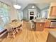 Open concept kitchen with hardwood floors, eat-in area, modern appliances, and seamless flow into the living room at 55 Ridge Haven Dr, Louisburg, NC 27549