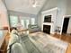 Cozy living room with fireplace, hardwood floors, vaulted ceiling, and natural light at 55 Ridge Haven Dr, Louisburg, NC 27549
