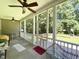 Screened porch with ceiling fans, backyard views, neutral rug, and decorative outdoor furniture at 55 Ridge Haven Dr, Louisburg, NC 27549