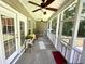 Relaxing screened porch with ceiling fans and views of the backyard and mature trees at 55 Ridge Haven Dr, Louisburg, NC 27549