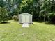 A metal storage shed in a grassy yard surrounded by trees at 55 Ridge Haven Dr, Louisburg, NC 27549