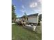Wide backyard view featuring deck, patio, wood benches, and room for outdoor living at 5809 Iris Lake Ct, Raleigh, NC 27604