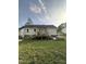 Exterior back view featuring a wooden deck, spacious lawn, and privacy at 5809 Iris Lake Ct, Raleigh, NC 27604