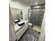 Bathroom with patterned tile floor and shower, and a modern vessel sink at 5809 Iris Lake Ct, Raleigh, NC 27604