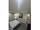 Bedroom featuring gray walls, laminate floors, picture window and decorative accents at 5809 Iris Lake Ct, Raleigh, NC 27604