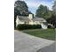Street view of a cozy home featuring a driveway and lush green landscaping at 5809 Iris Lake Ct, Raleigh, NC 27604