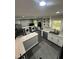Modern kitchen with white cabinets, stainless appliances, an island and eat-in breakfast bar at 5809 Iris Lake Ct, Raleigh, NC 27604