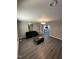 Open living room with modern flooring, neutral walls, and contemporary lighting at 5809 Iris Lake Ct, Raleigh, NC 27604