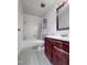 Bathroom featuring a tub, toilet, striped shower curtain and single sink vanity at 5810 Shady Grove Cir, Raleigh, NC 27609