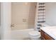 The bathroom has a toilet, tub, and shower with neutral tiling at 5810 Shady Grove Cir, Raleigh, NC 27609
