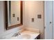 Bathroom featuring a single sink vanity with a wood framed mirror at 5810 Shady Grove Cir, Raleigh, NC 27609