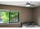 Bedroom featuring a window with natural light, a ceiling fan, and a simple bed at 5810 Shady Grove Cir, Raleigh, NC 27609