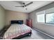 Neutral bedroom with a grey headboard, plaid blanket, a wooden dresser, and natural lighting at 5810 Shady Grove Cir, Raleigh, NC 27609