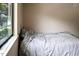 Cozy bedroom with a window offering a pleasant view and a comfortable bed at 5810 Shady Grove Cir, Raleigh, NC 27609