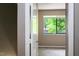 View from a doorway looking into a bedroom with a window at 5810 Shady Grove Cir, Raleigh, NC 27609