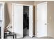 Bedroom with an open closet, housing dark clothes on hangers at 5810 Shady Grove Cir, Raleigh, NC 27609