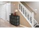 Inviting entryway featuring a staircase with white railings and a dark storage console at 5810 Shady Grove Cir, Raleigh, NC 27609