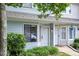 Townhome exterior with a well-maintained lawn and garden leading to the front doors at 5810 Shady Grove Cir, Raleigh, NC 27609