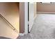 Carpeted hallway with white trim leading to another room with a closet at 5810 Shady Grove Cir, Raleigh, NC 27609